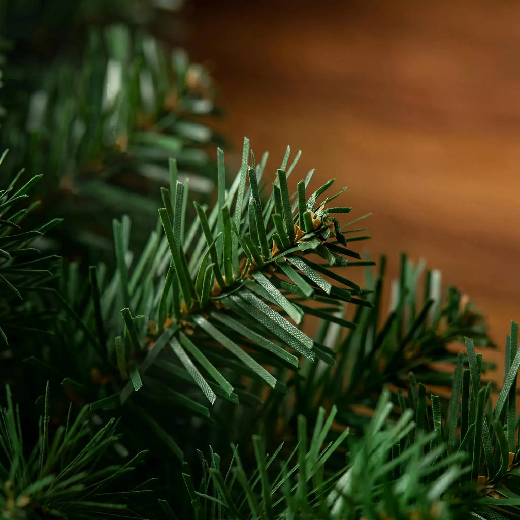 Pine Christmas garland with red berries and pine cones on a mantel, image 3 of 4