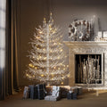 White flocked pre-lit Aspen fir tree by a fireplace, image 1 of 4