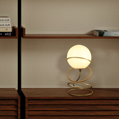 White glass globe table lamp on a matte gold spiral stand, image 4 of 5