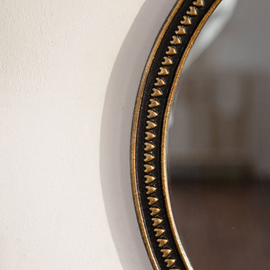 Round wall mirror with beaded gold frame above a console, image 3 of 5