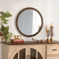 Round wall mirror with beaded gold frame above a console, image 1 of 5
