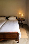 Rose gold tulip two-light table lamp, 18.75 in tall, on a bedside table