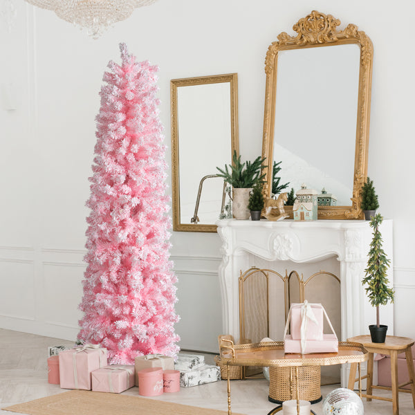 Pink snow-flocked pencil Christmas tree by a staircase, image 2 of 6