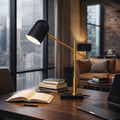 Black dome desk lamp with brass arm on a marble base, image 1 of 5