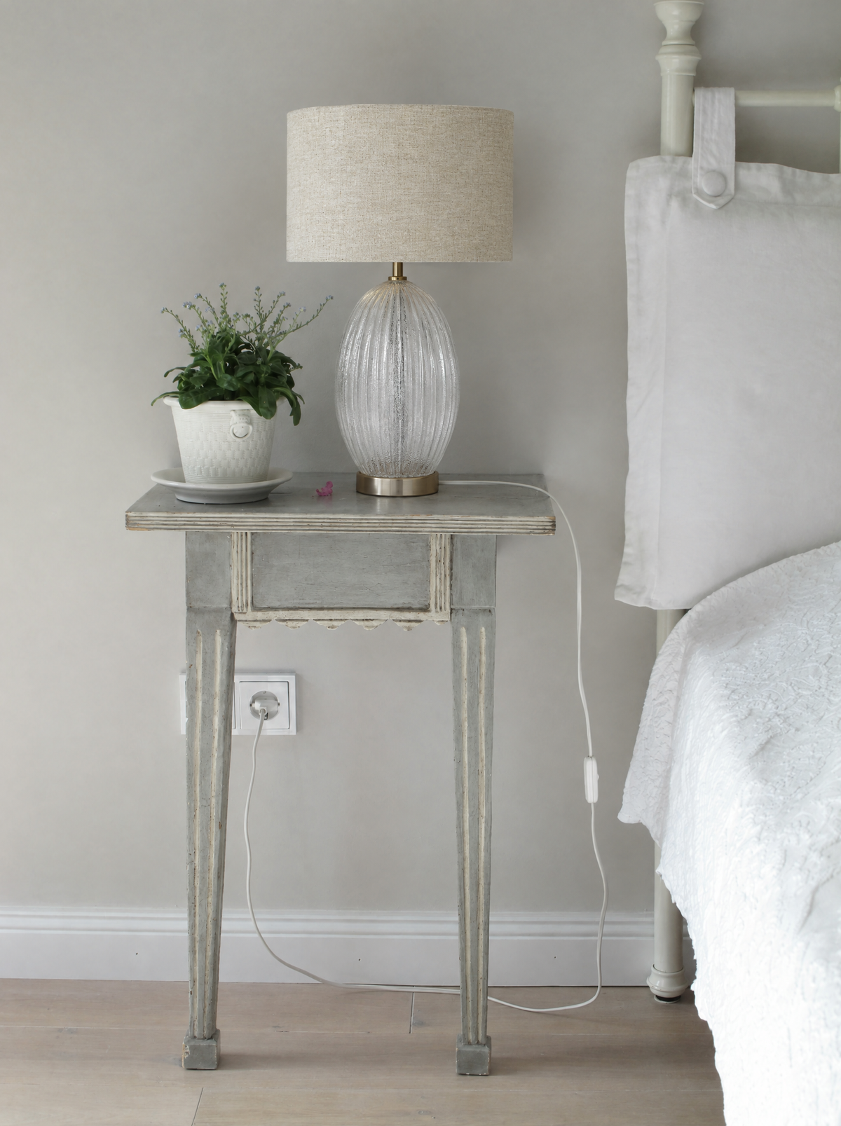 Ribbed Clear Glass Table Lamp with Gold Base and Drum Shade in a real room, wider view